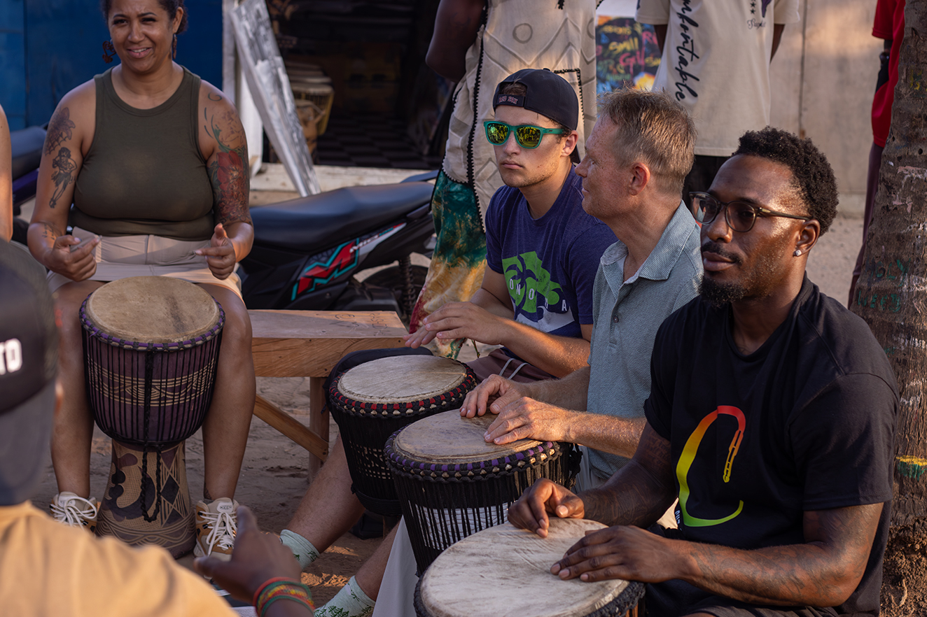 Students and community members gathered in a drumming circle